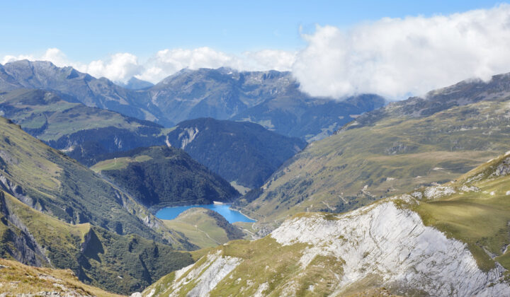 Alpine landscapes near Col du Bonhomme with peaks and an Alpine lake.