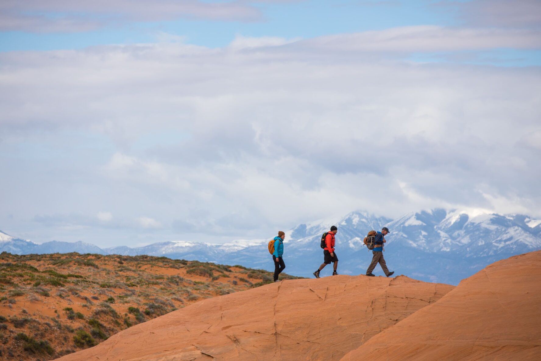 Three hikers and mountains in Utah
