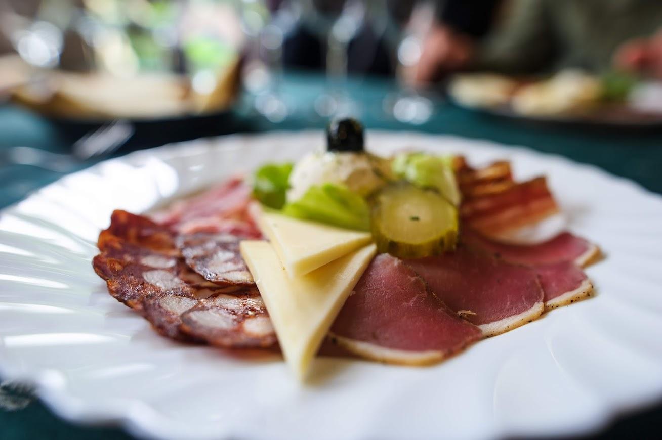 A plate with traditional Croatian delicacies consisting of cured meats and cheeses