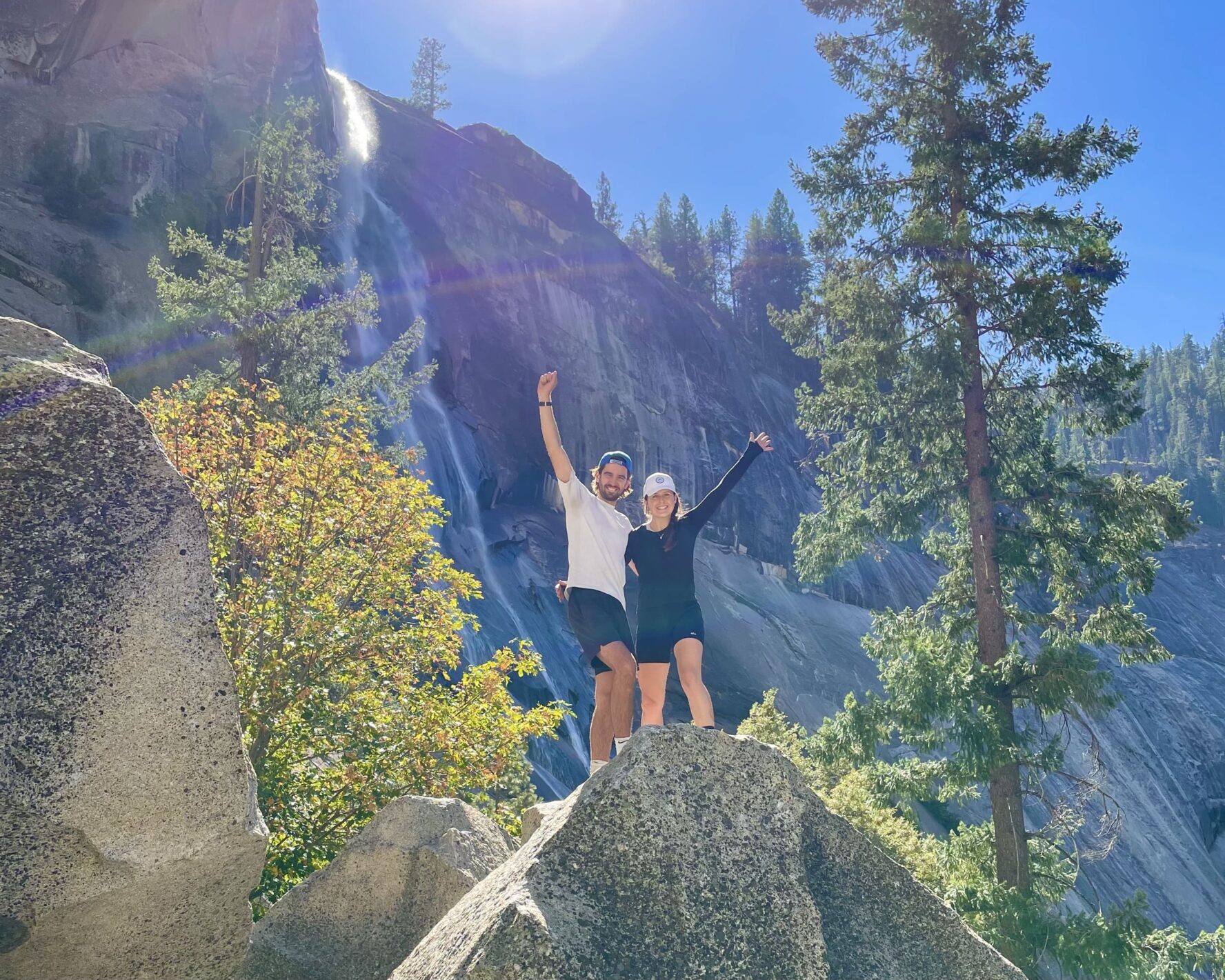 Two hikers posing on a rock at Nevada Falls