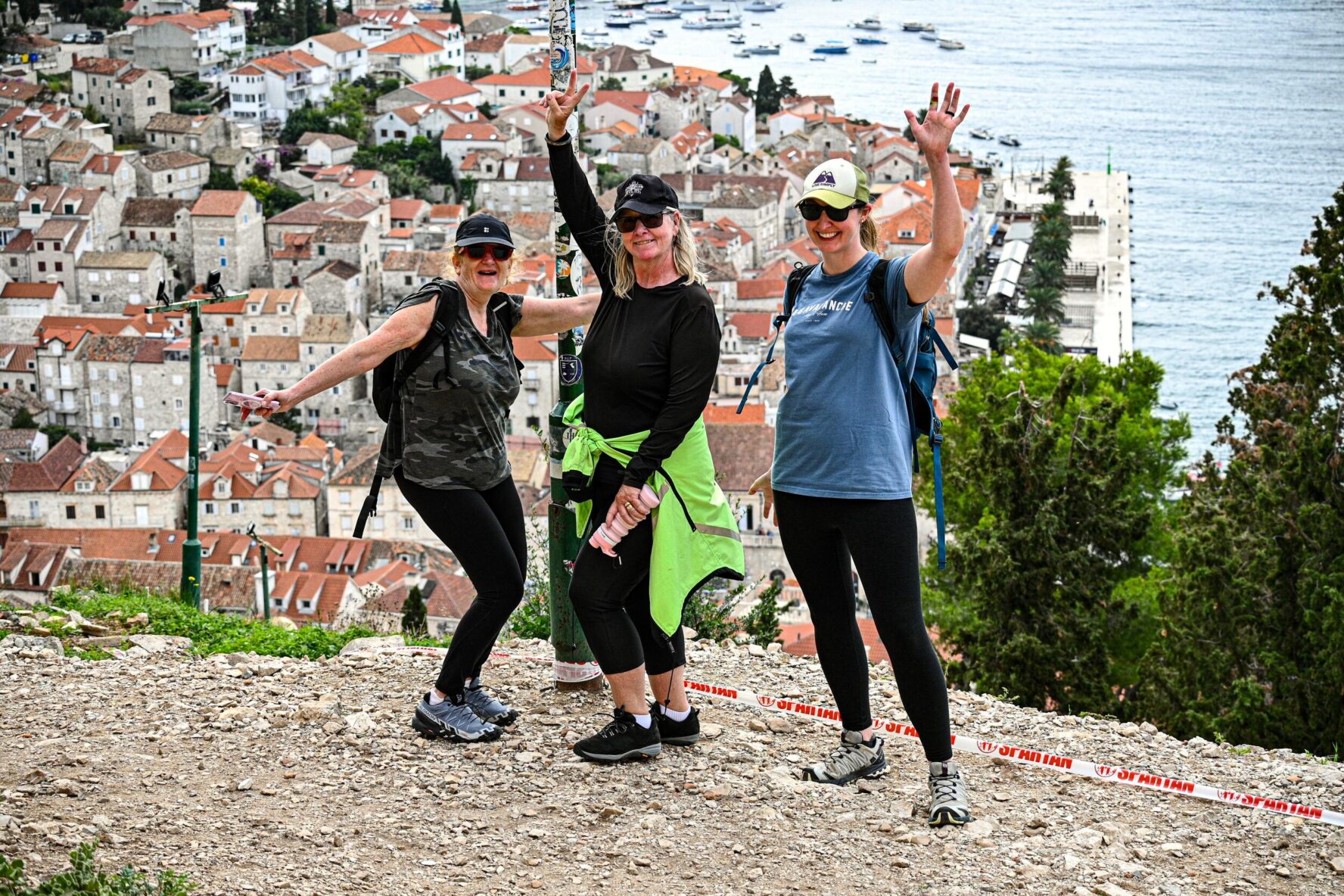 Hikers posing on a viewpoint above the town of Hvar