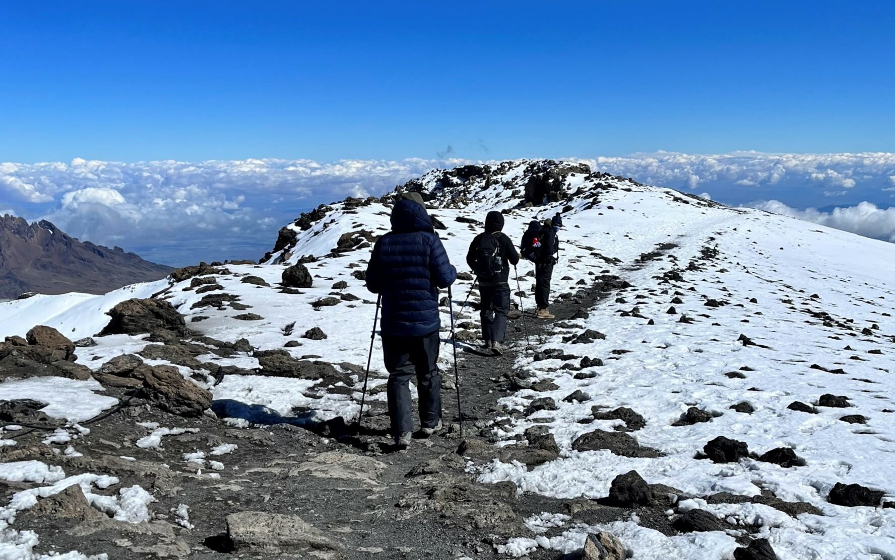 Trekkers walking through the alpine desert area during their Kilimanjaro climb.
