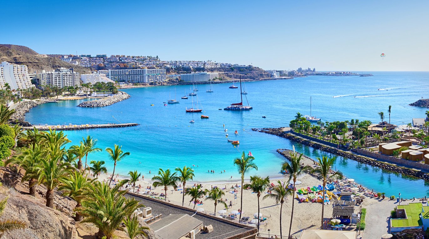 Anfi beach surrounded by turquoise waters in Maspalomas, Gran Canaria.