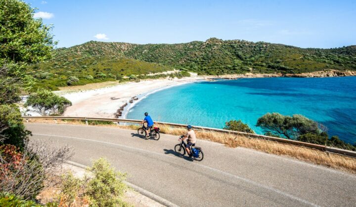 Cycling along a beach in Sardinia