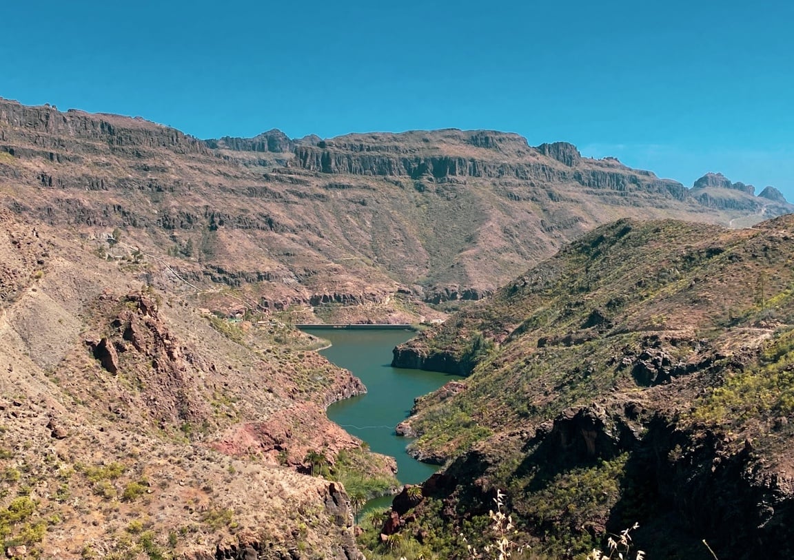 A canyon surrounded by arid mountains in Gran Canaria, seen during a GR131 hiking trip.