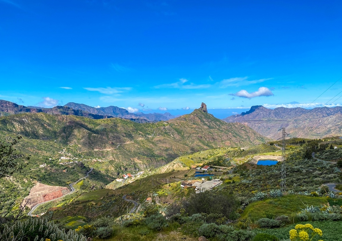 Expansive view of volcanic mountains, forests, and valleys in the interior of the Gran Canaria island.