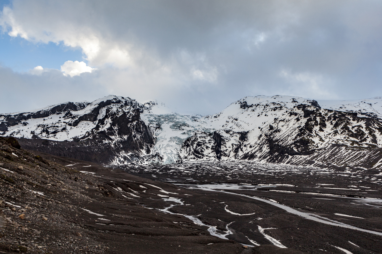 Black ash lagoon at base of Gígjökul outlet glacier from Eyjafjallajokull ice cap