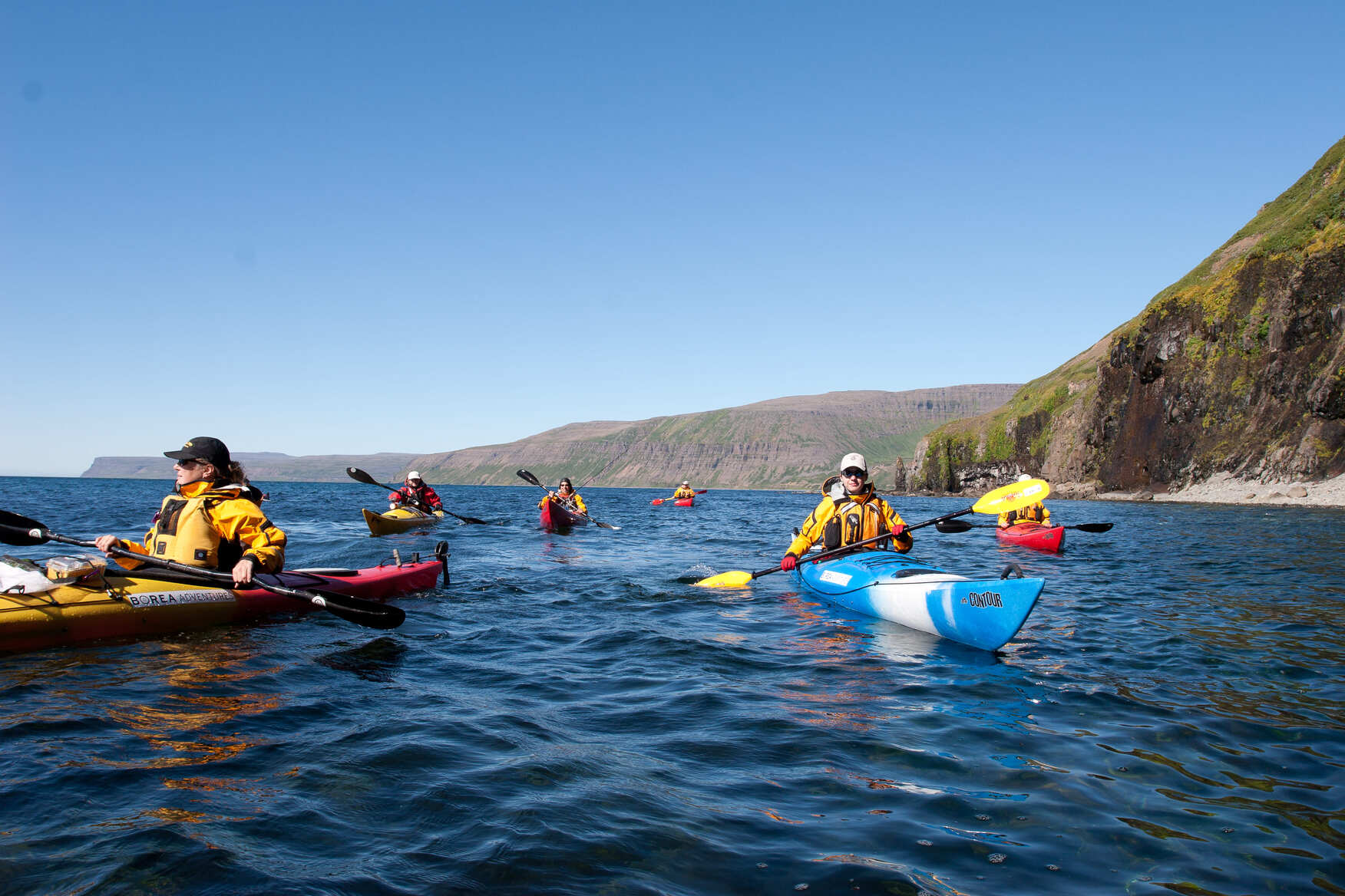 Group of kayakers paddling in Iceland