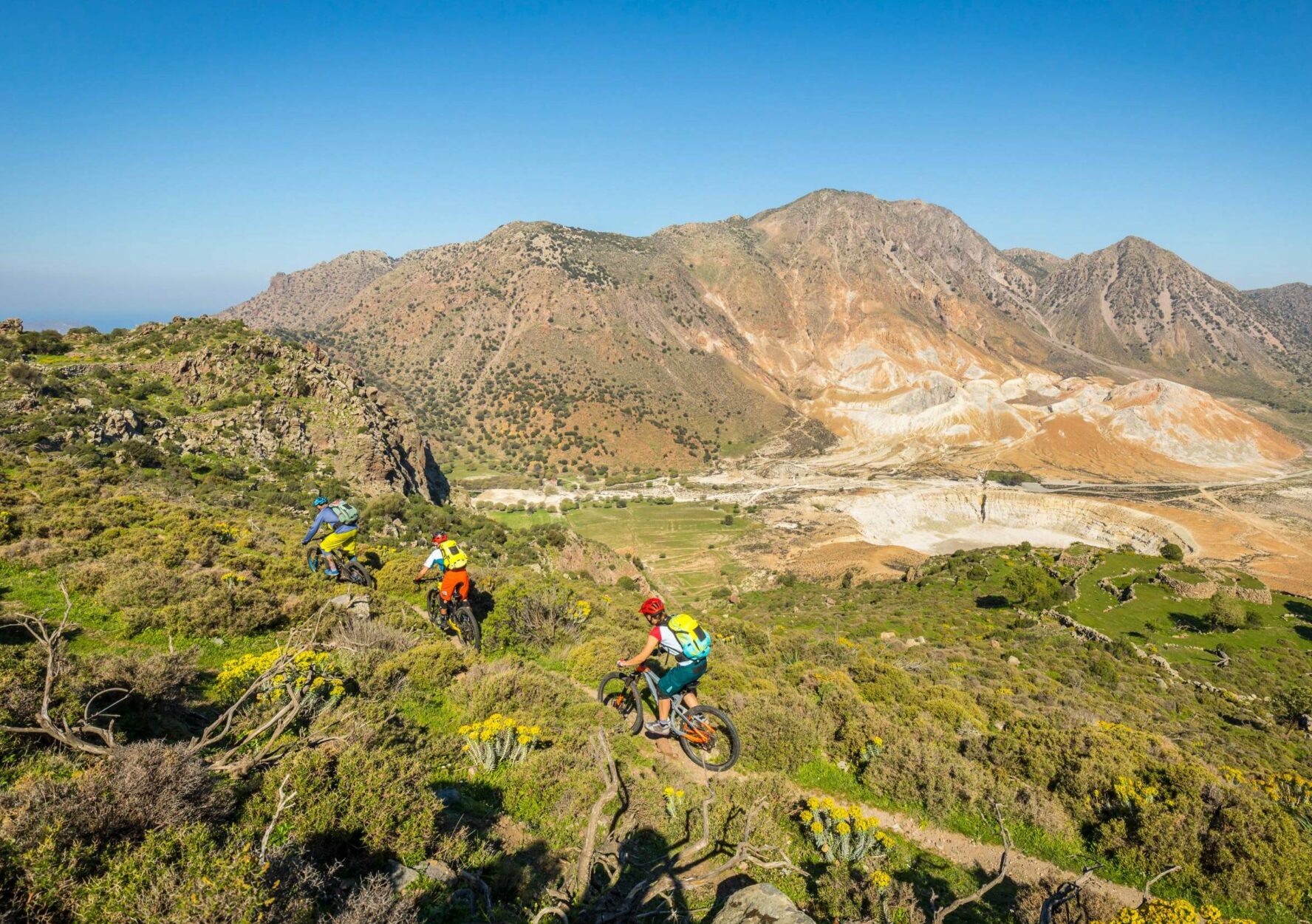 Mountain bikers riding through theMediterranean wilderness on the South Aegean Greek island of Nisyros.