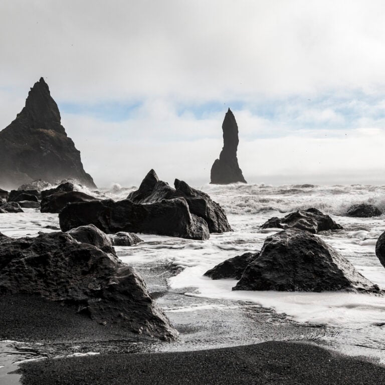 Beautiful seascape with the Reynisdrangar basalt sea stacks on the shoreline of Reynisfjara beach, near Vík í Mýrdal, Iceland