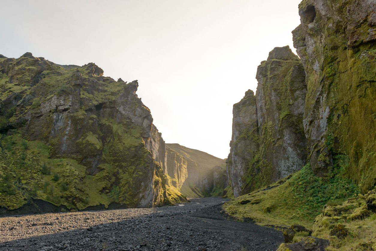 Stakkholtsgjá canyon in Iceland during a beautiful sunny summer morning with sunlight touching the side walls of the canyon.