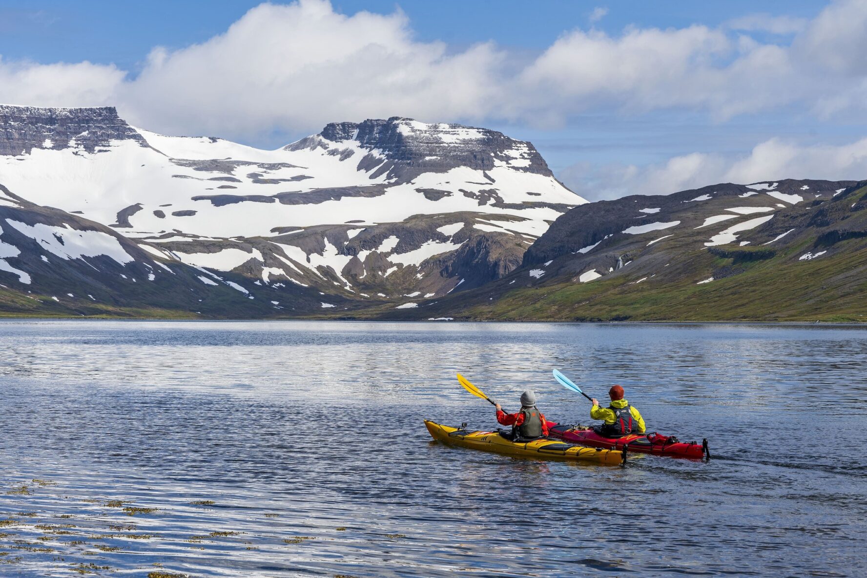 Two kayakers paddling in west Iceland