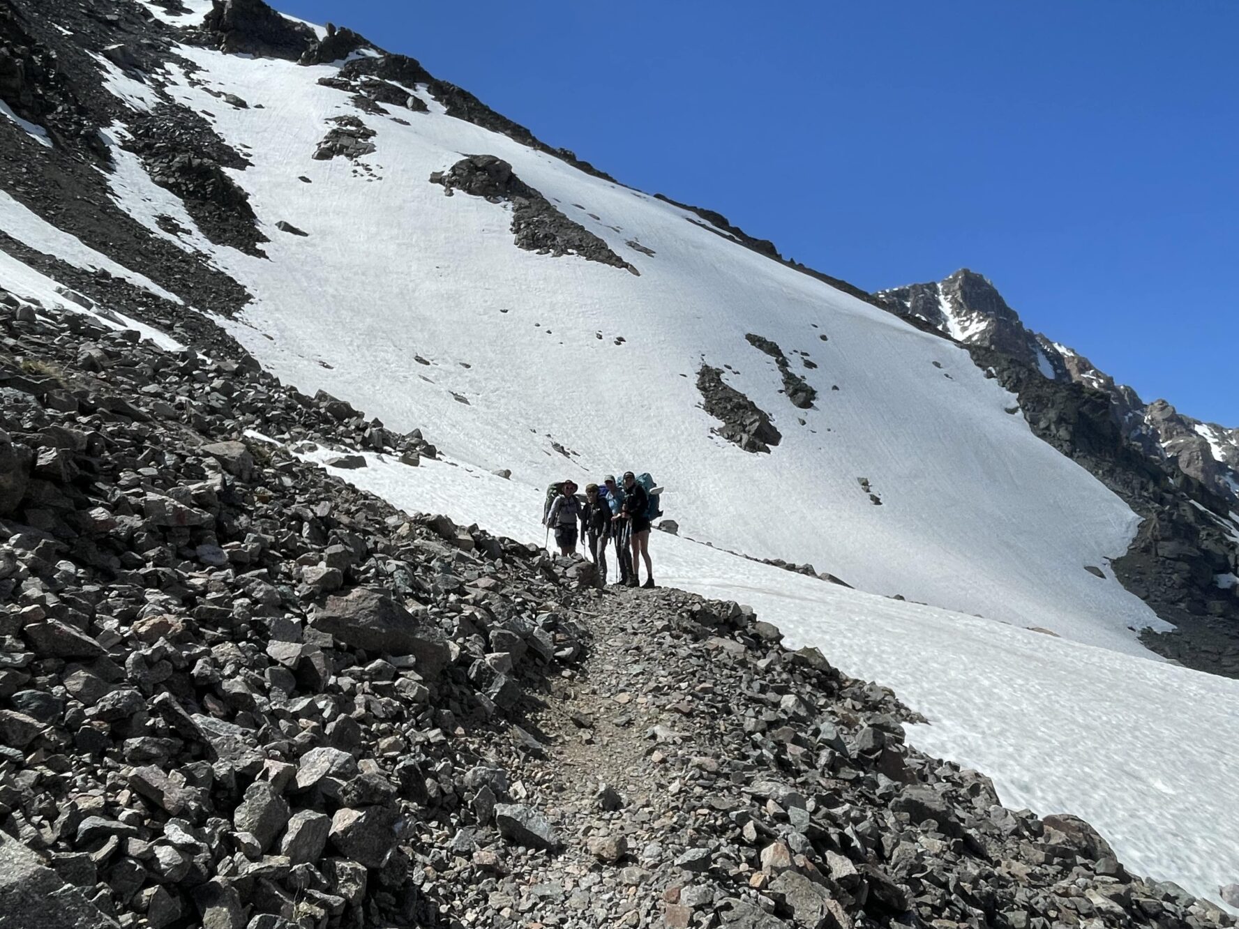 hikers on a glacier in Beartooth Mountain