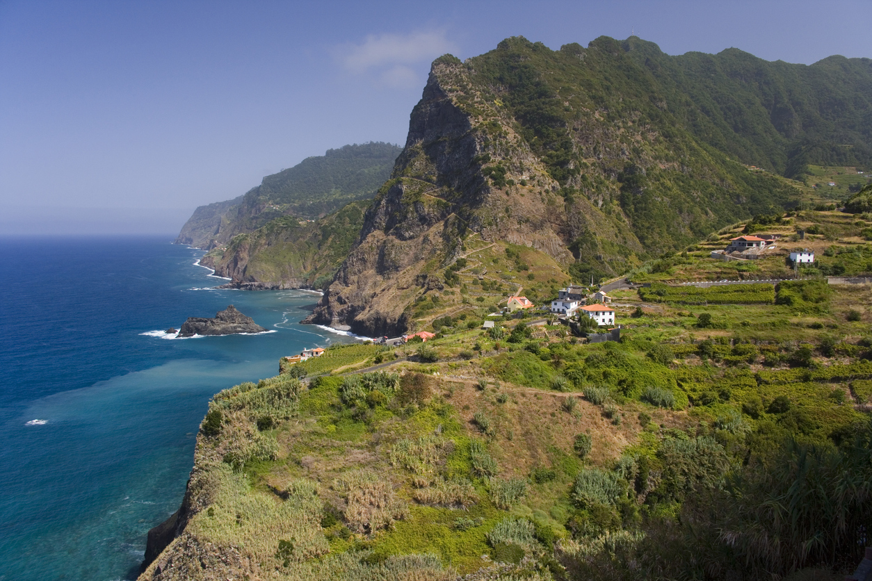 Dramatic coastal scenery of the village of Boaventura and the Arco de Sao Jorge (mountain range) on the north coast of the Portuguese Island of Madeira