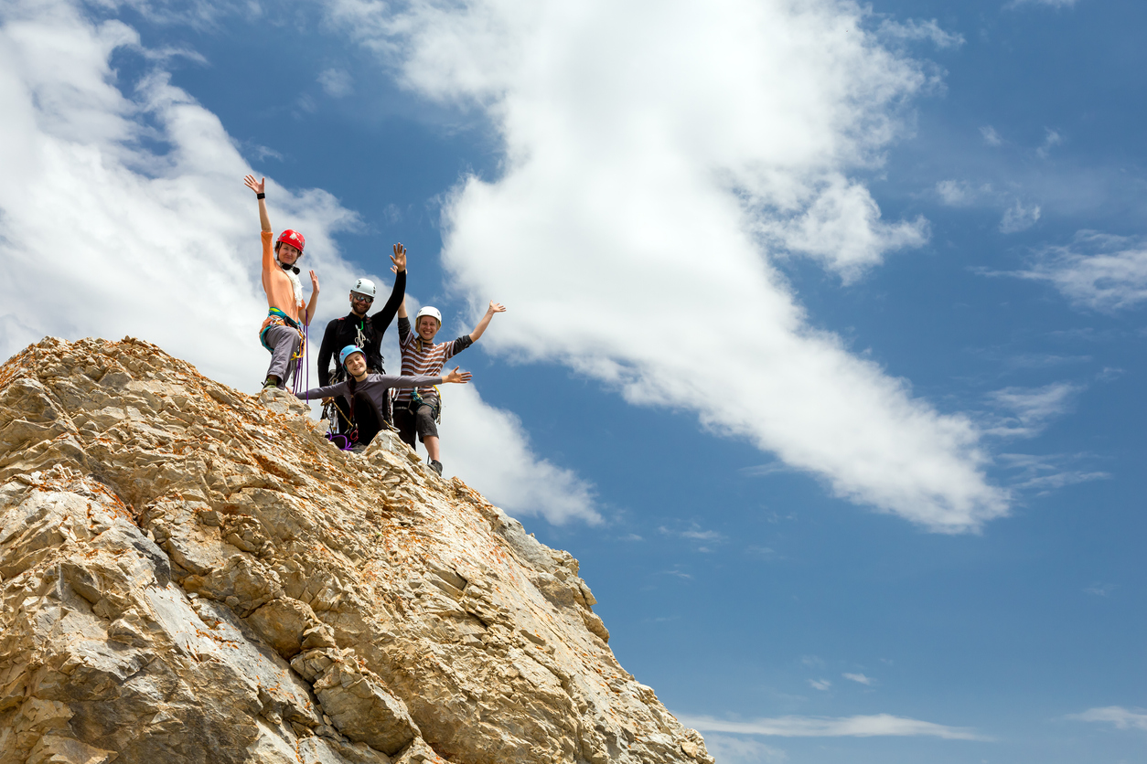 A group of climbers happy after an ascent during their rock climbing course in Mammoth Lakes.