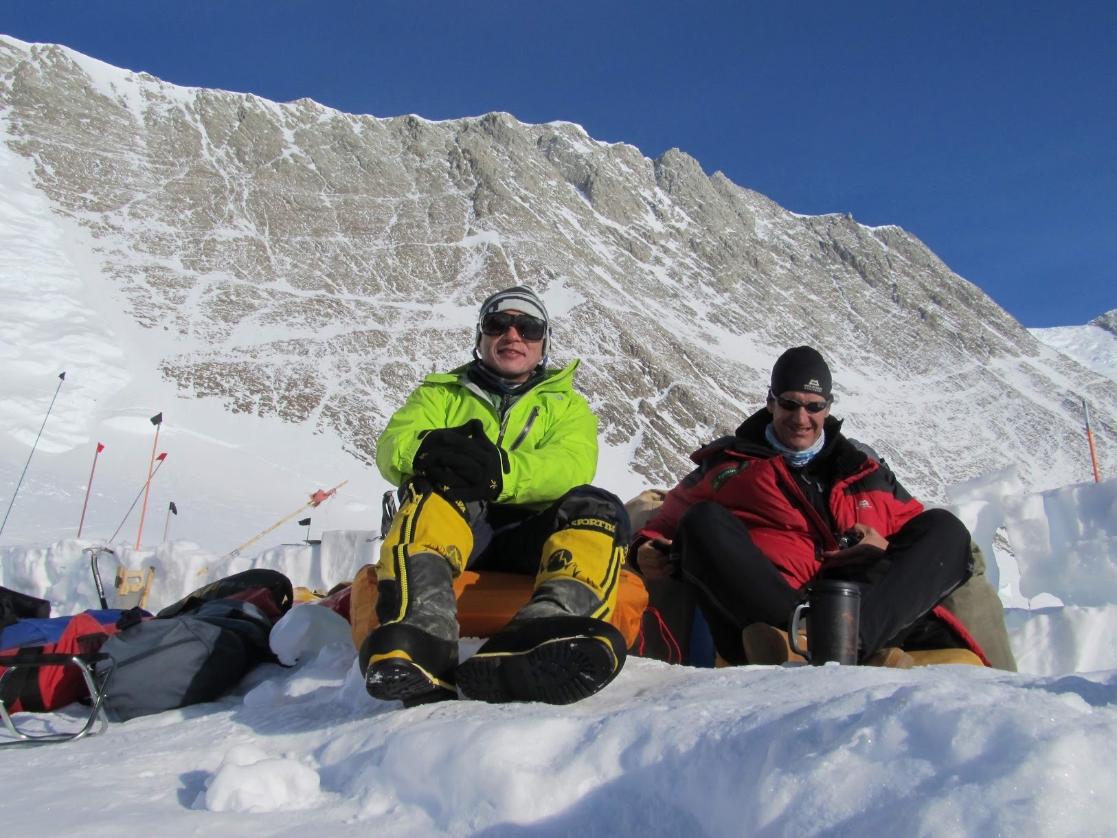 Tw mountaineers drinking coffee and having fun in their camp in Antarctica.