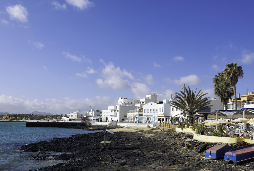 Whitewashed houses lining the riva of the town of Corralejo, Fuerteventura,