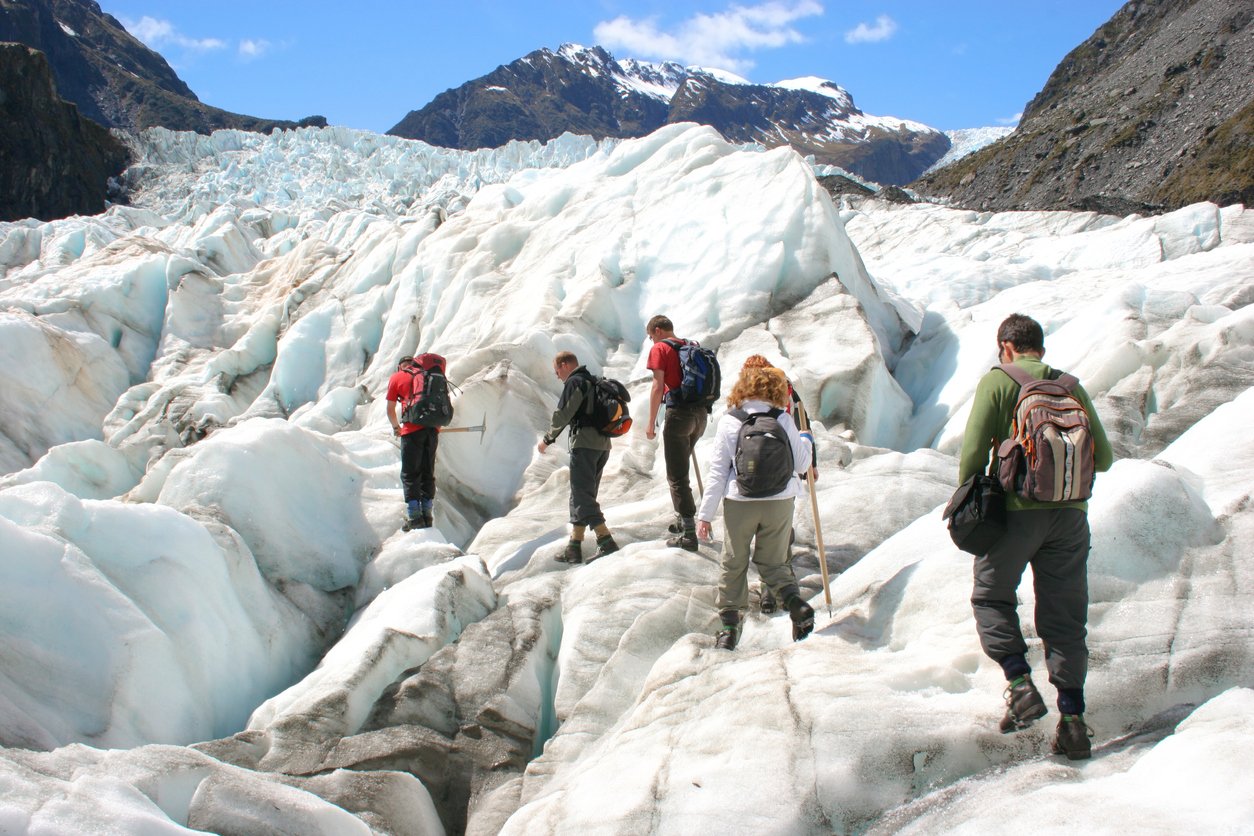 Cyclists going for a short hike at Franz Josef Glacier, New Zealand.