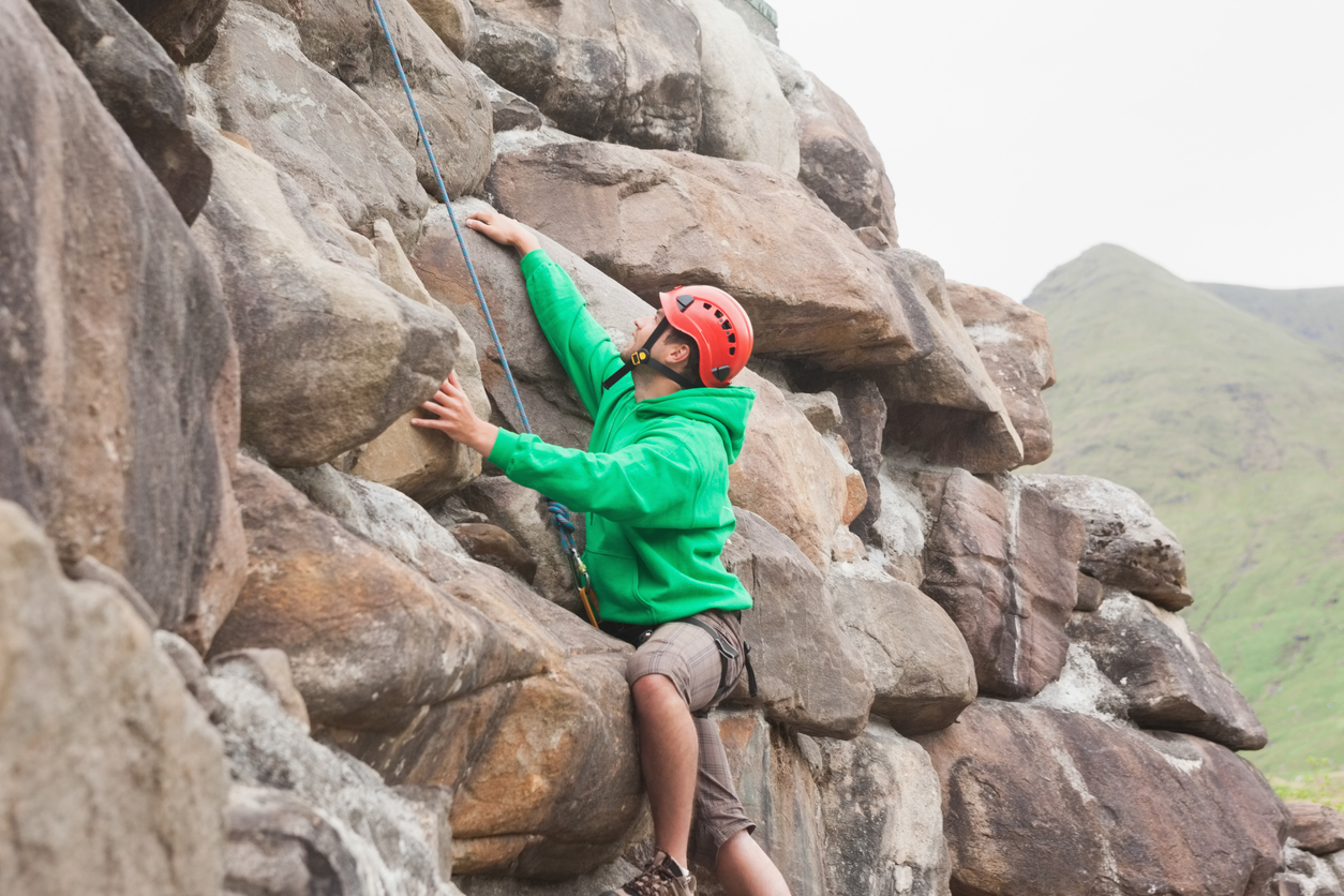 A novice rock climber navigating terrain with granite slaves near Mammoth Lakes.