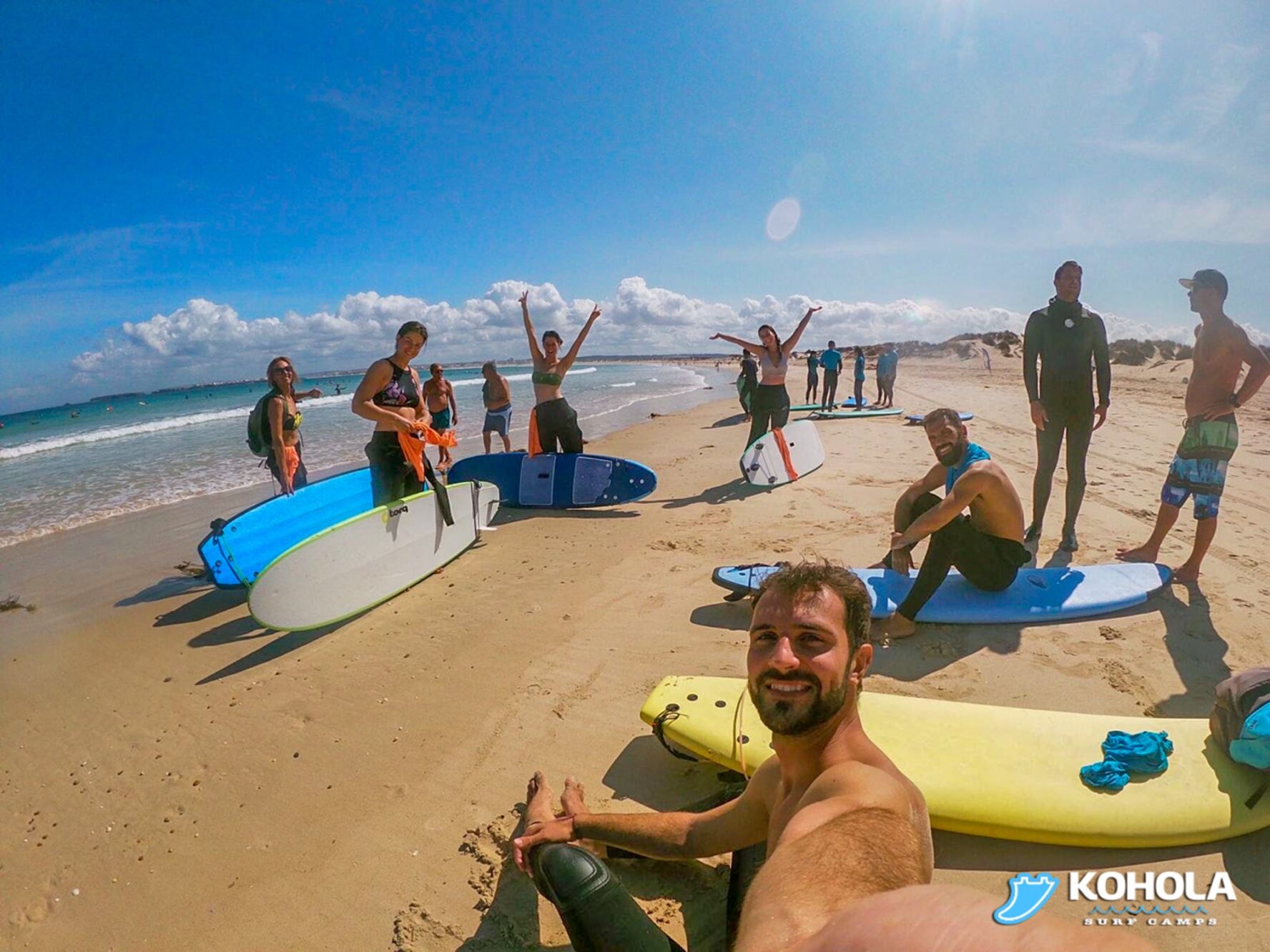 Group of surfers on a beach in Peniche