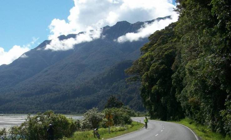 A cyclist on the famous Haast Pass, along the Great West Coast cycle route.
