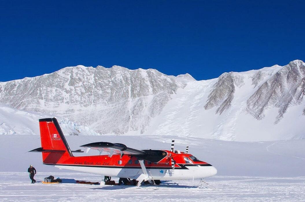 A red helicopter surrounded by Antarctic landscapes.