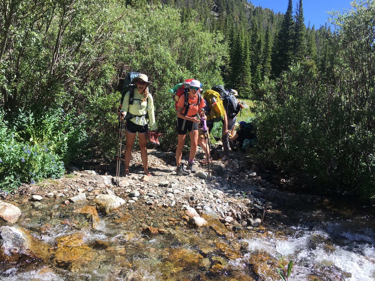 Hikers next to stream in Beartooth