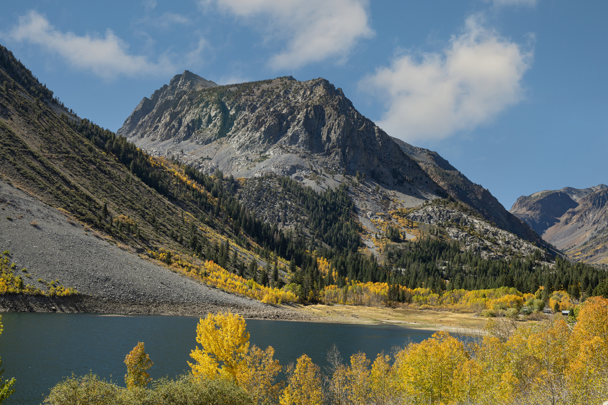 A beautiful Eastern Sierra landscape with a mountain, autumn trees and a lake, near Mammoth Lakes.