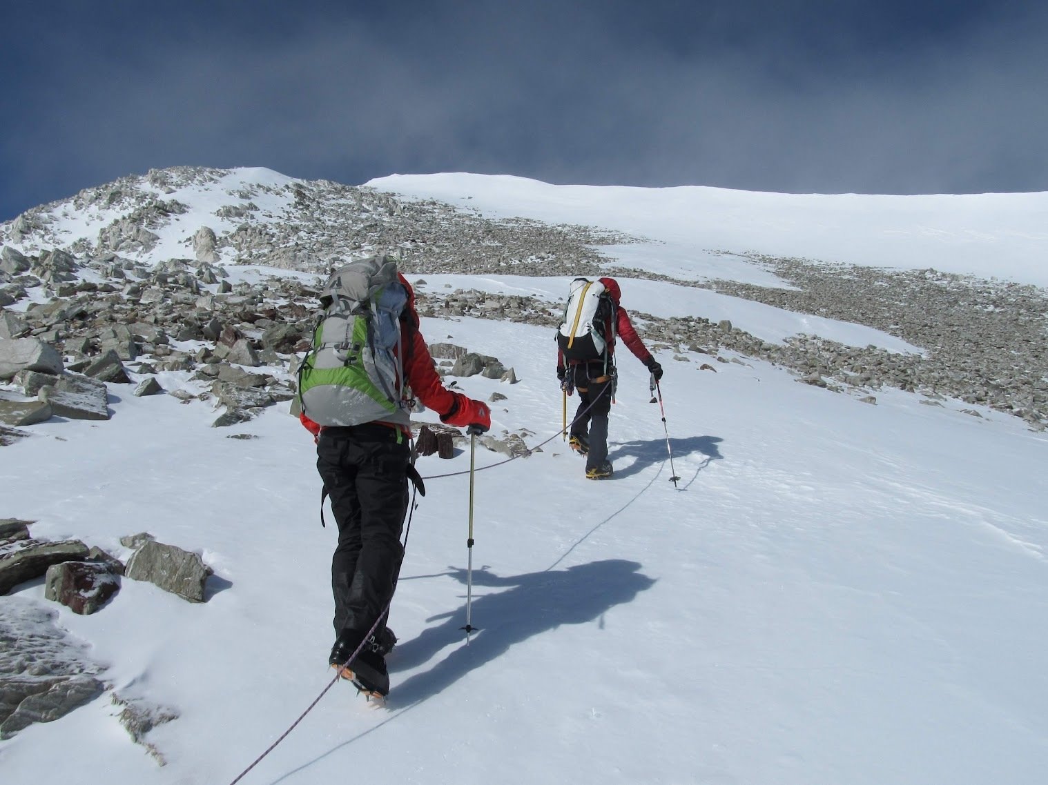 Mountaineers traversing rugged and icy terrain on a pretty flat section of the Mt Vinson climb.
