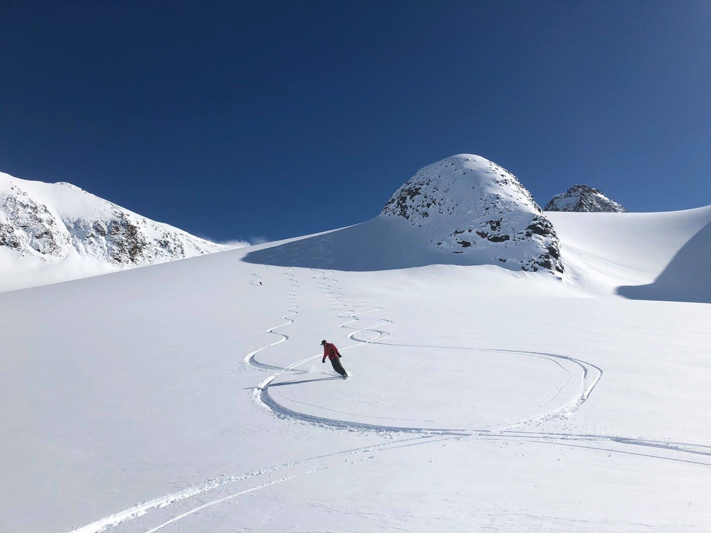 Skier carving lines in Greenland