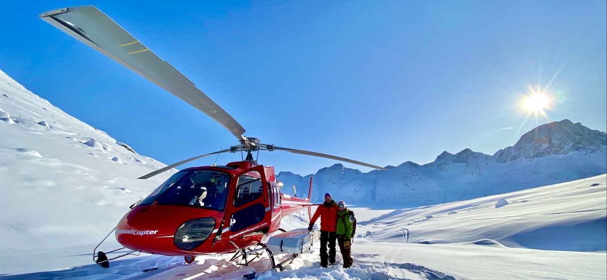 Two skiers and a heli in Greenland