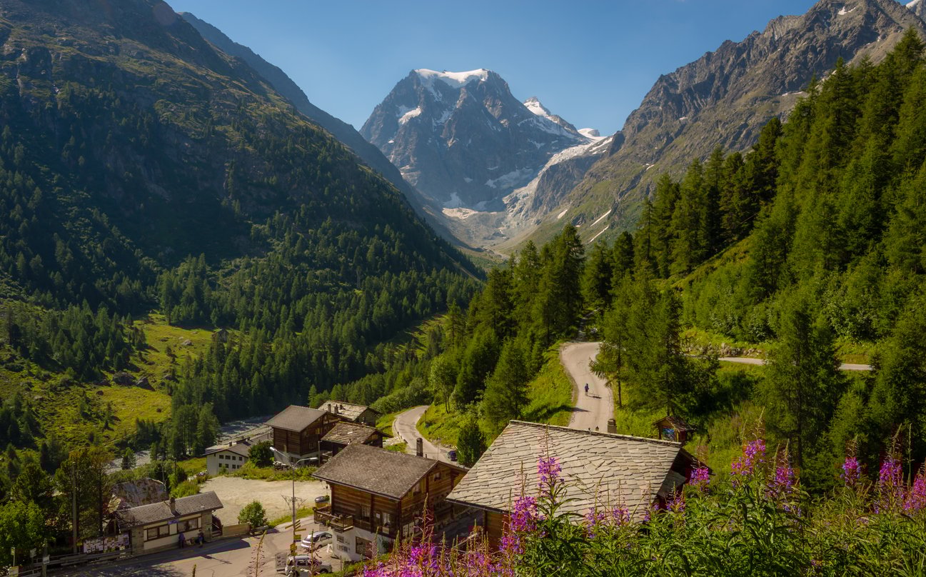 Swiss village of Arolla with traditional wooden houses, situated at the floor of a narrow Alpine valley.