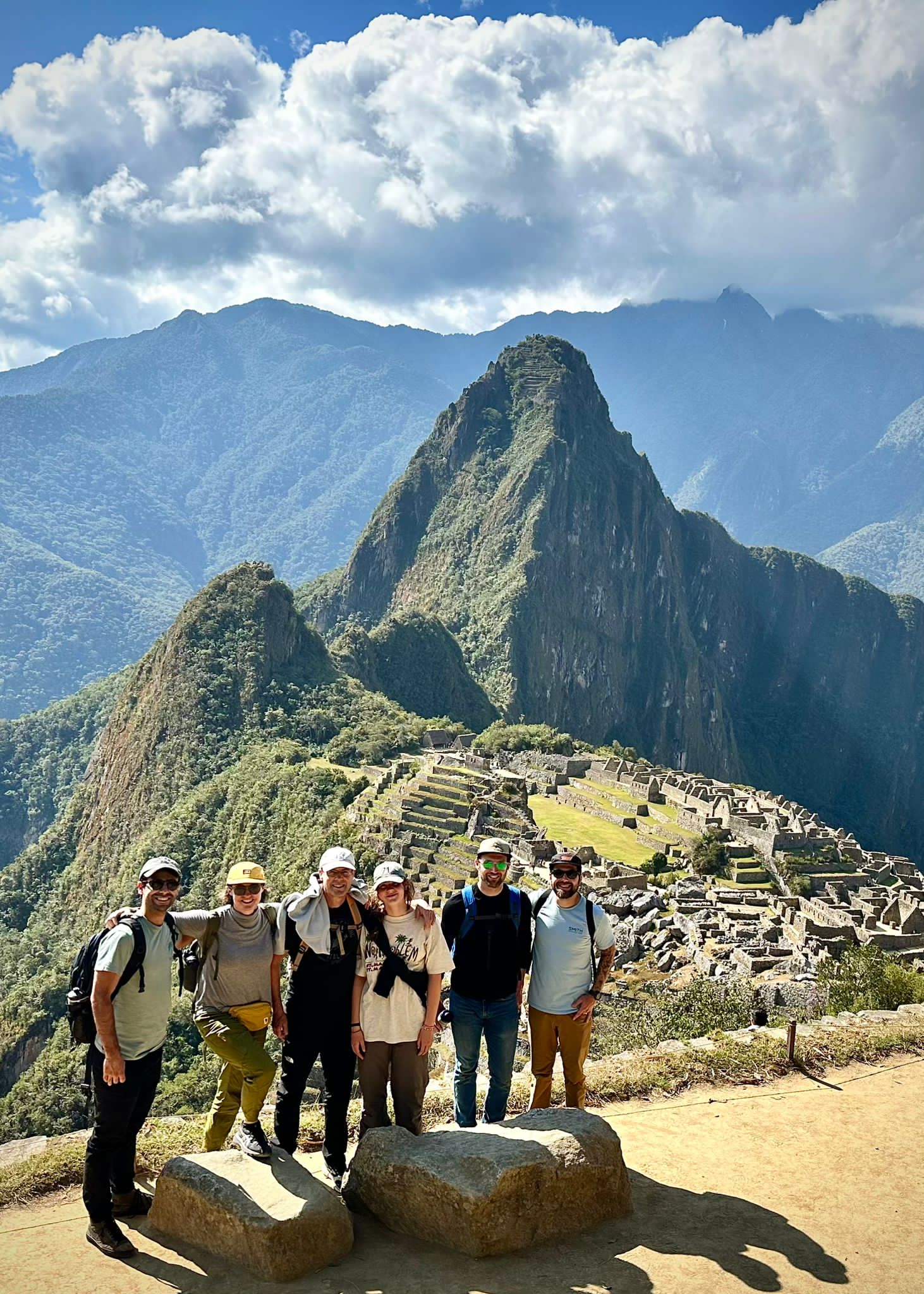 Bikers posing in front of a mountain top