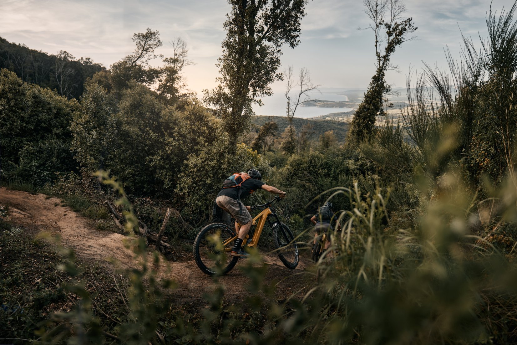 An e-mountain biker shredding a trail near the coast in Tuscany.