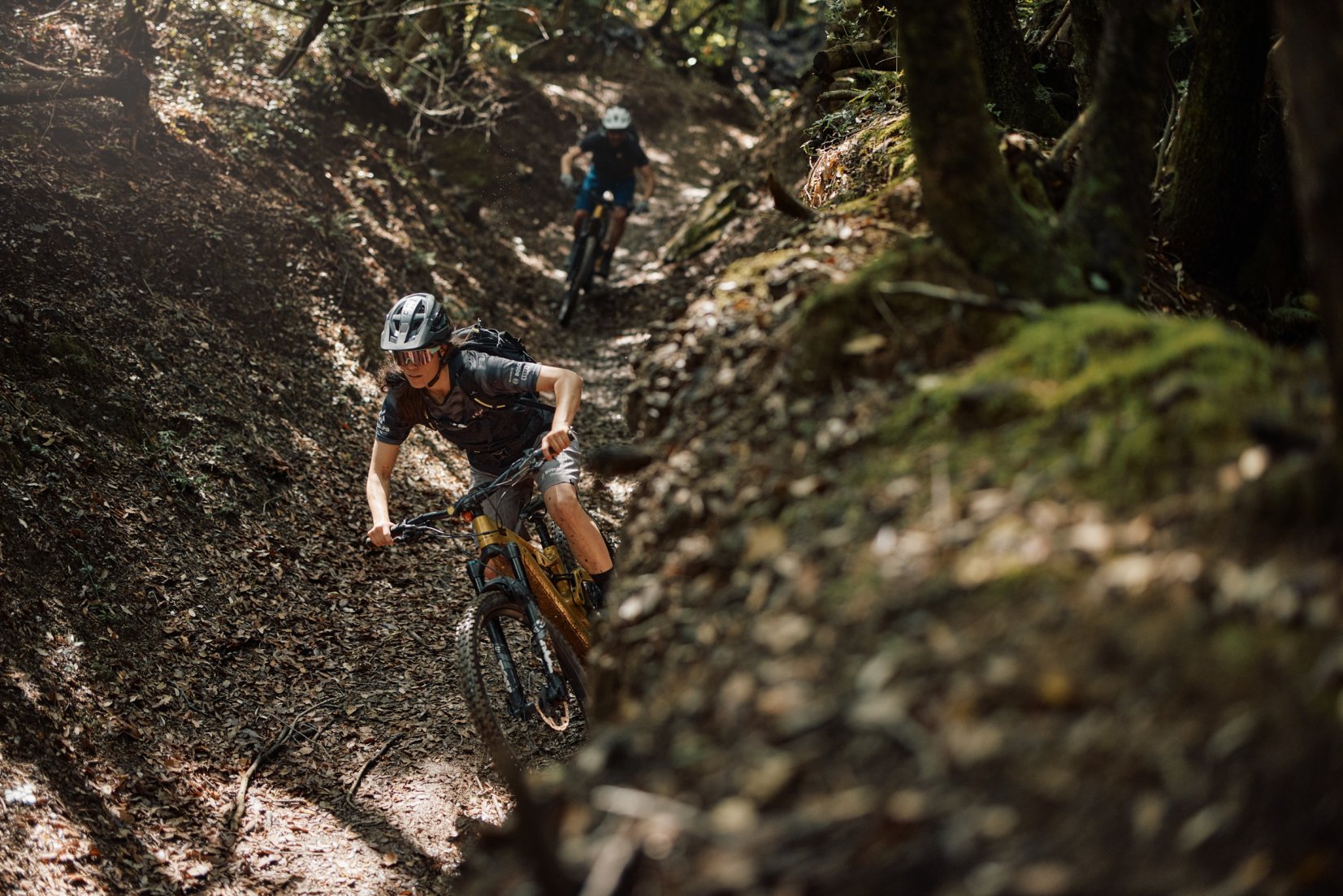 An e-MTBer riding a forest trail in Tuscany.