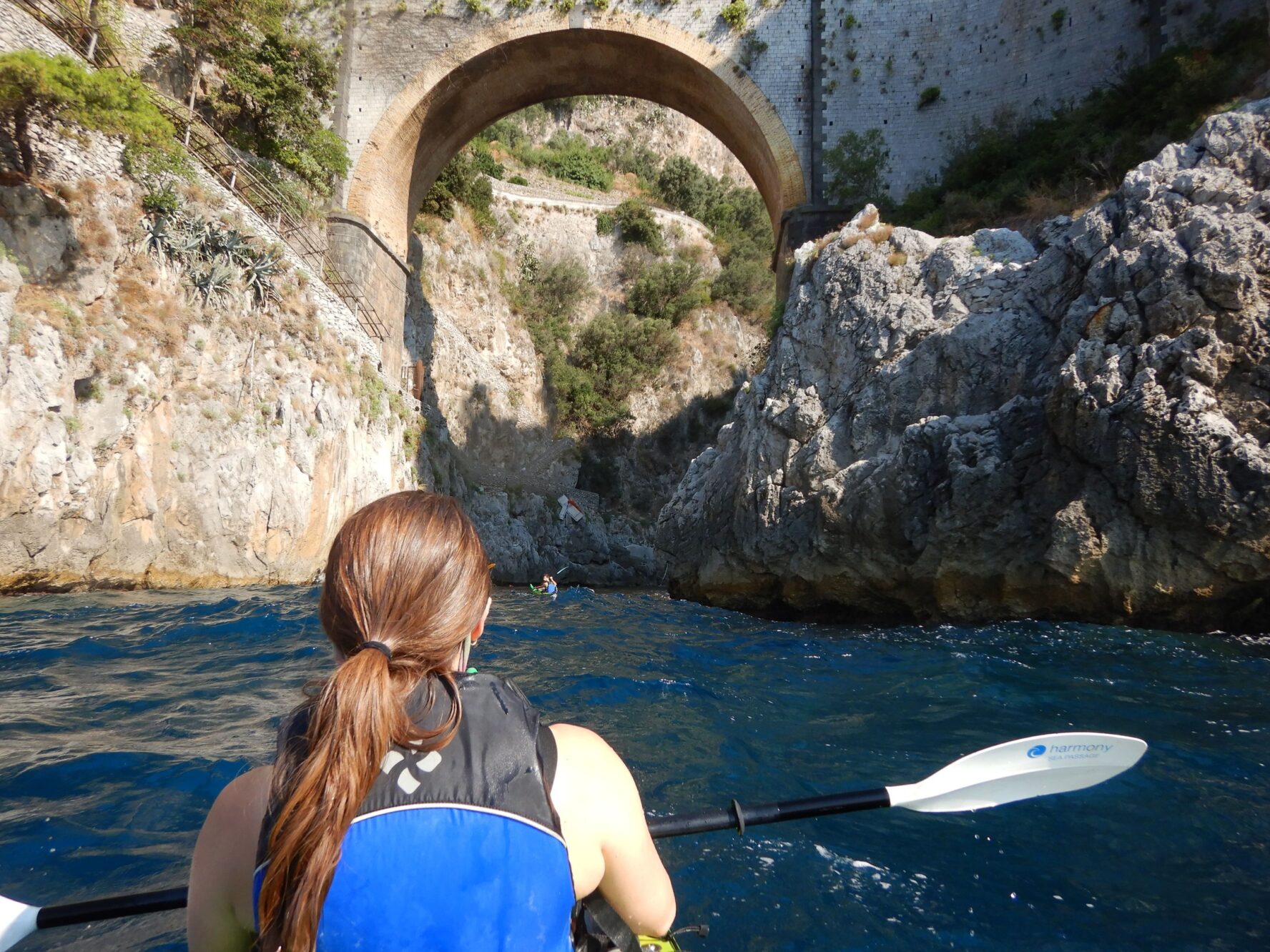 Kayaking towards an arch on the Amalfi coast