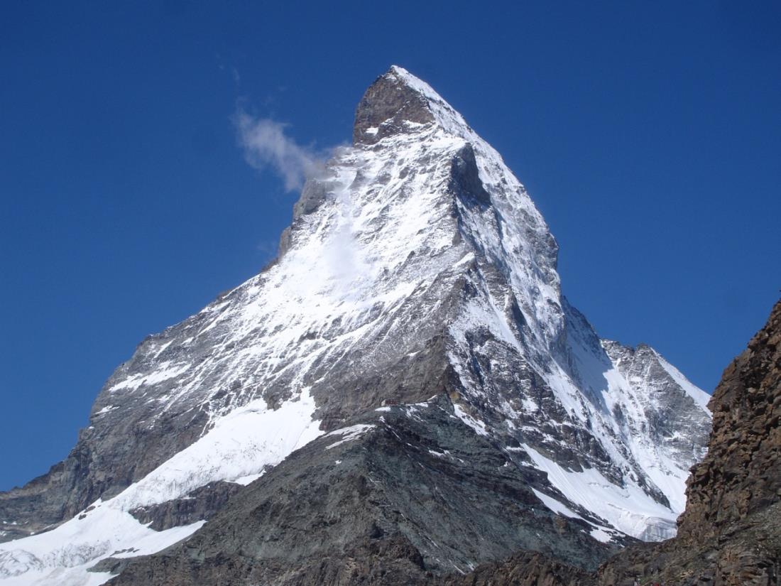 Snow-dusted, pyramidal peak of Matterhorn, in the Swiss Alps.