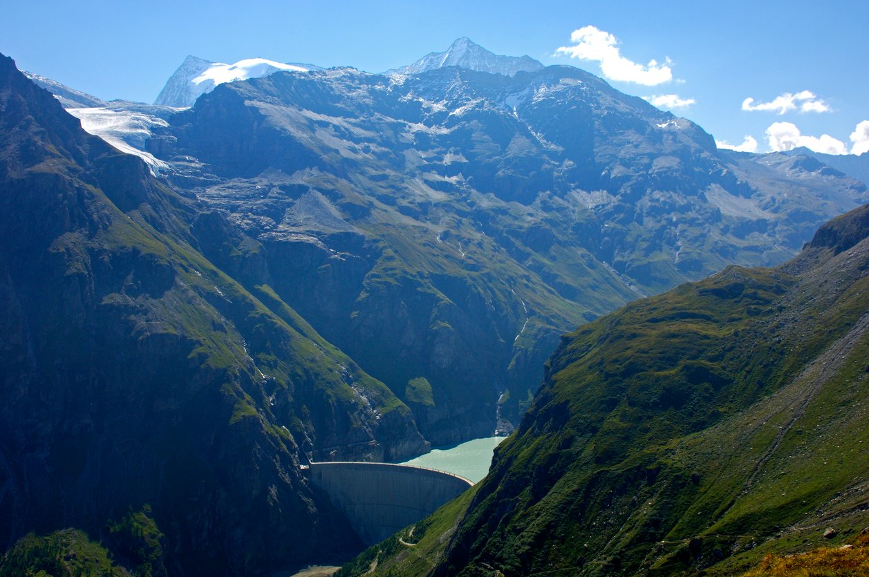 Mauvoisin reservoir surrounded by a dam and Swiss mountains.