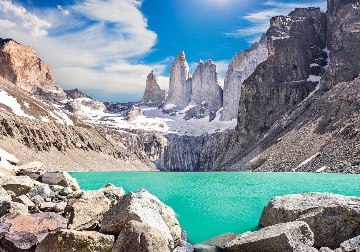 Granite spires above an aquamarine lake, seen during the all-woman O Circuit trek.