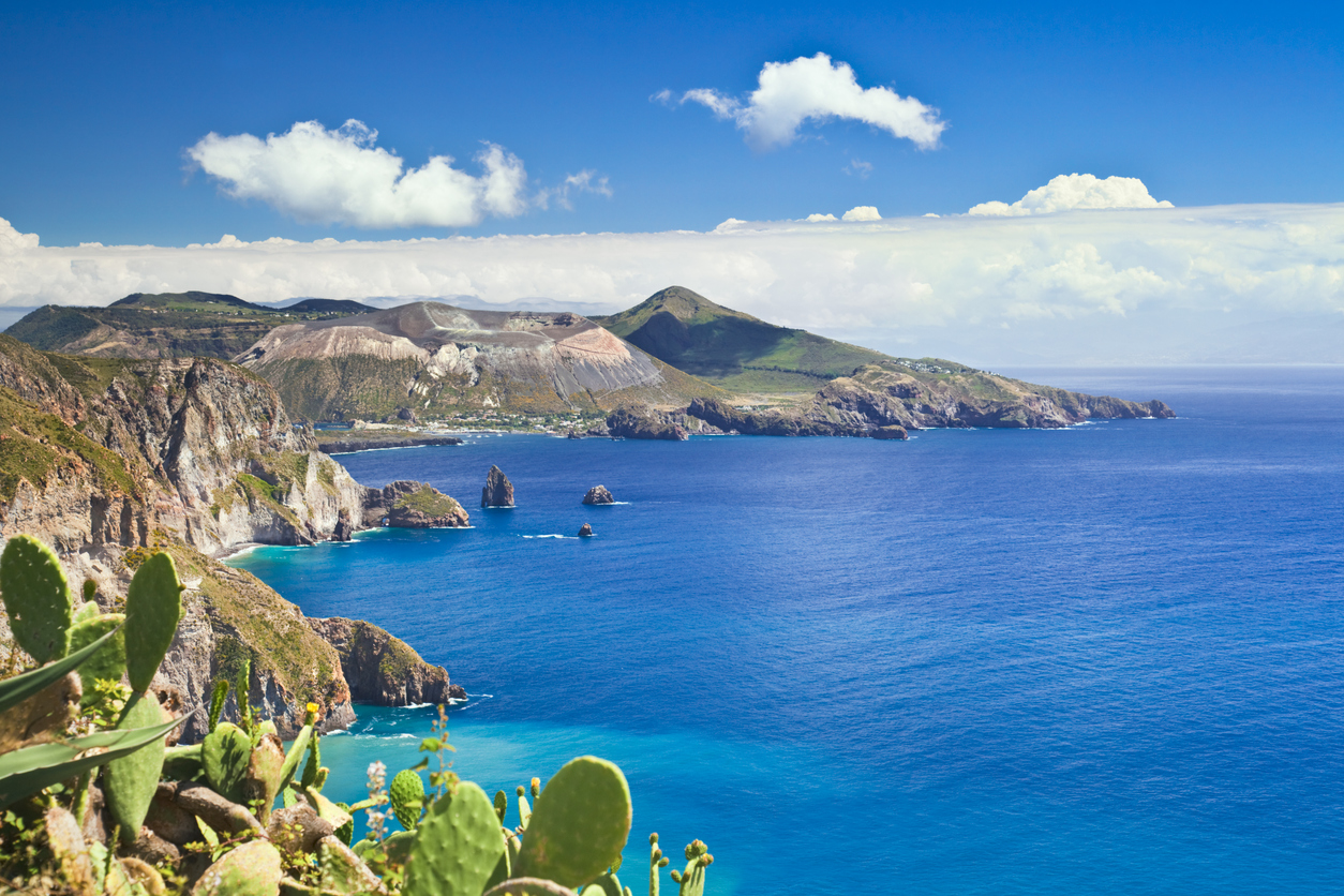 The dramatic coastline of Vulcano, one of the Aeolian Islands, surrounded by turquoise waters.