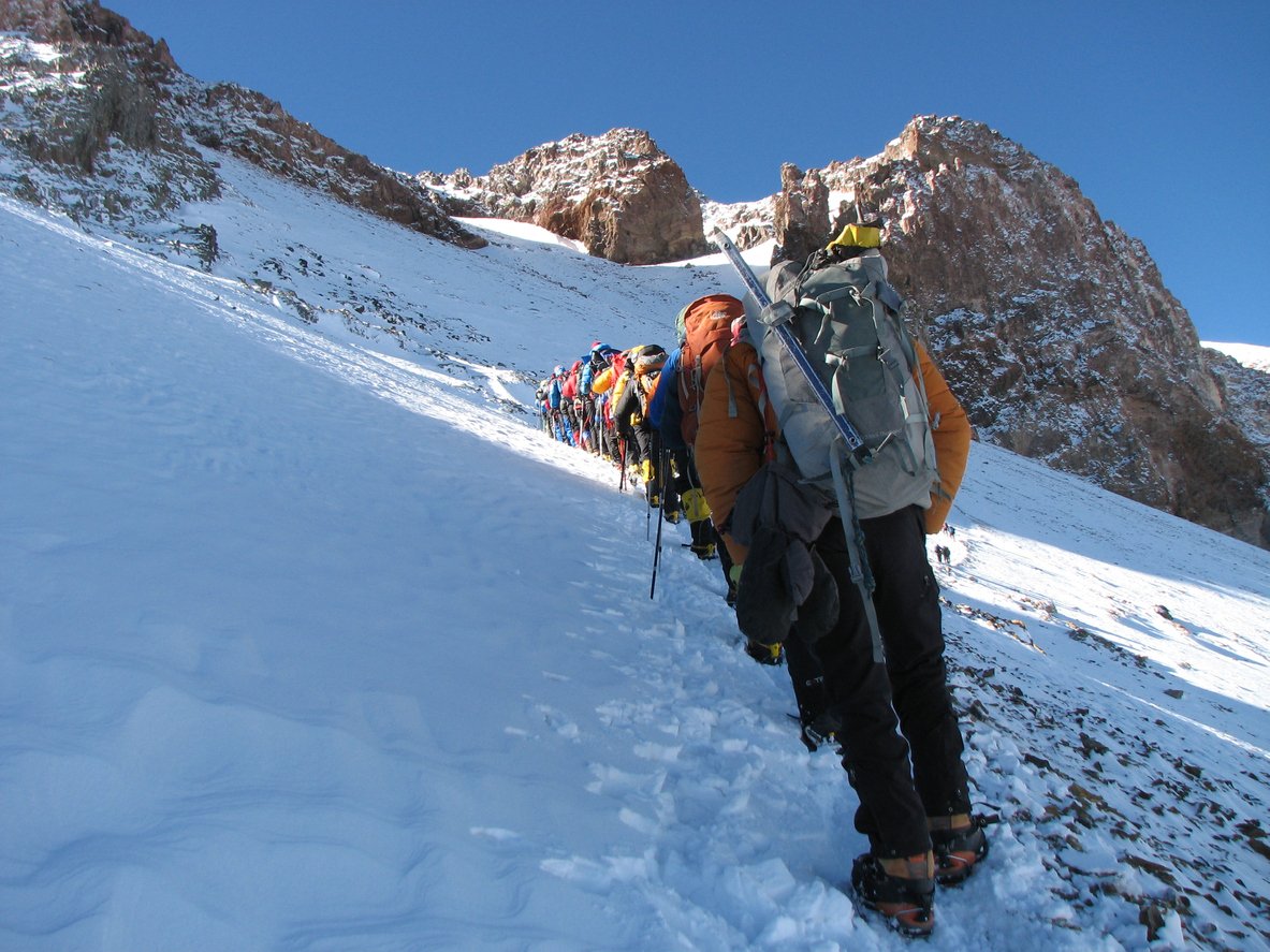 High-altitude trekkers trekking in the winter environment, summiting Aconcagua.
