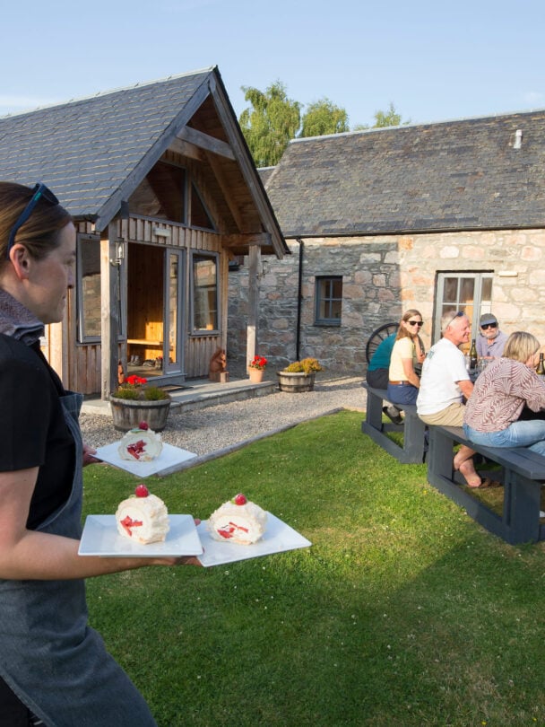 Two hikers crossing a shallow river