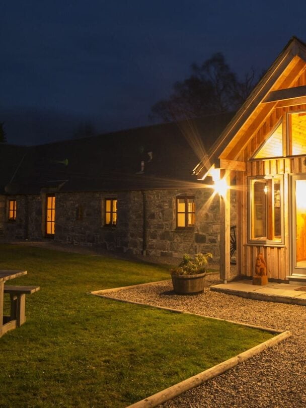 Two hikers crossing a shallow river