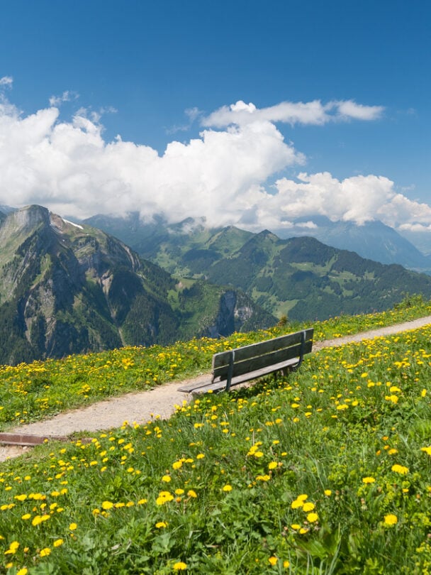 Hikers on a trail beside the Oeschinen lake, Swiss Alps.