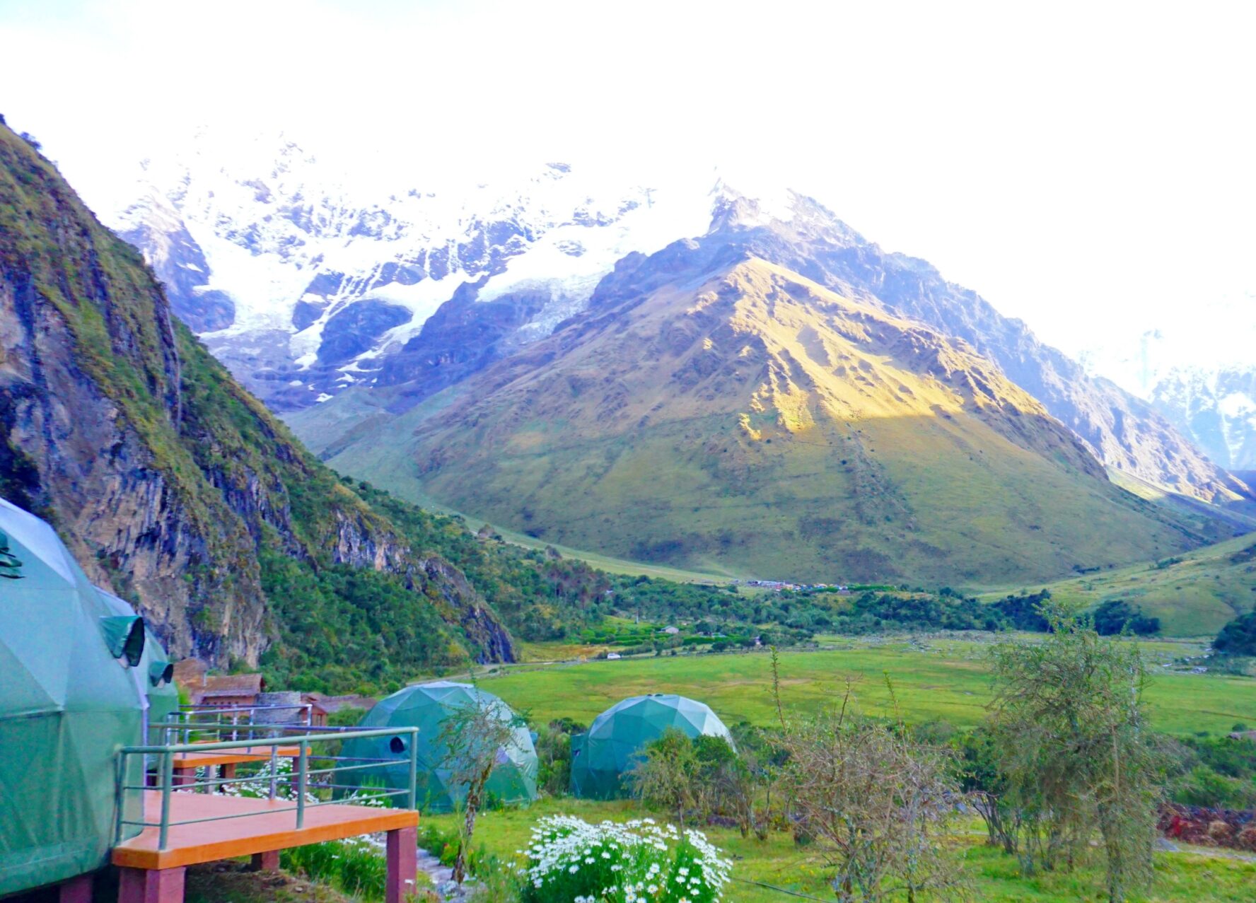 A campsite below snowy peaks in the Andes, Salkantay Trek to Machu Picchu.