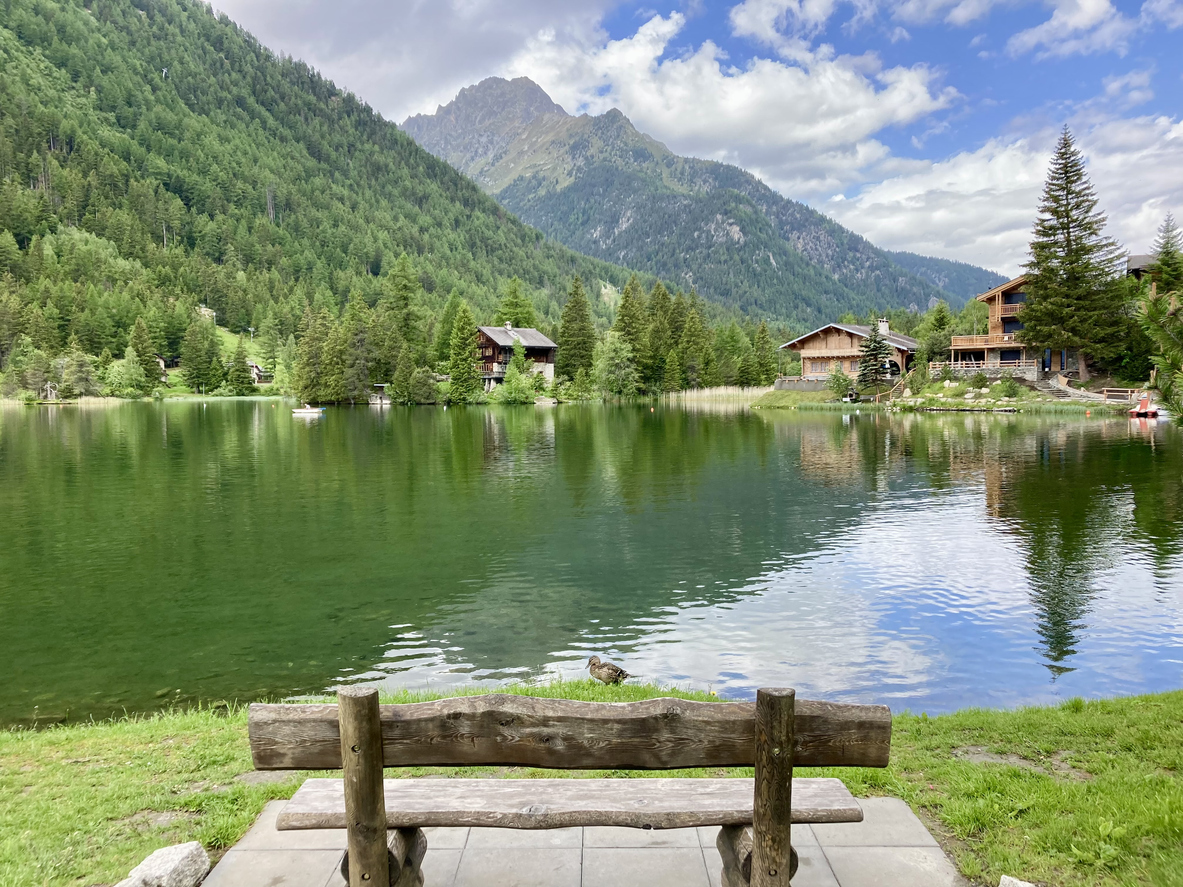A bench by a lake in Champex, an Alpine village in Switzerland.
