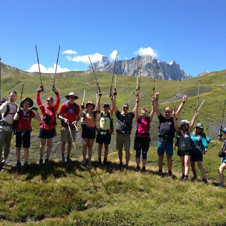 Group of happy hikers on TMB highlights