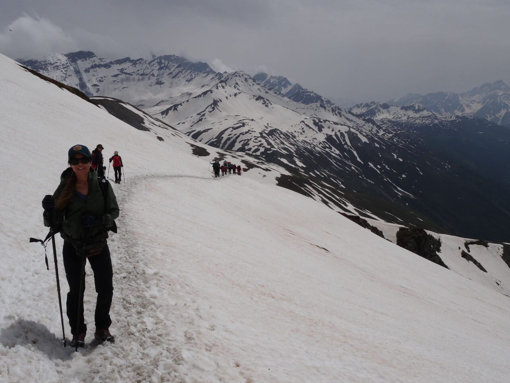 Happy hikers in snow-carpeted Alps
