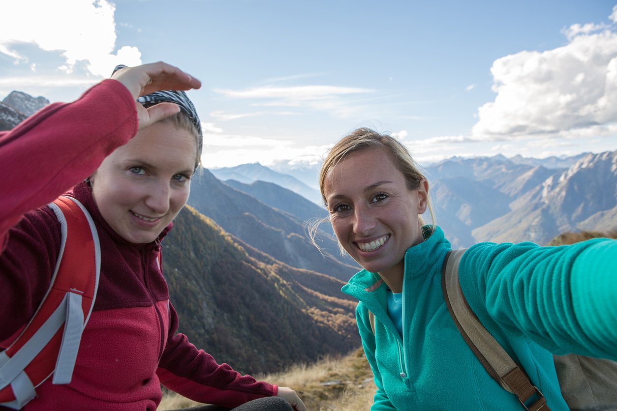 Happy hikers taking a selfie on Tour du Mont Blanc.