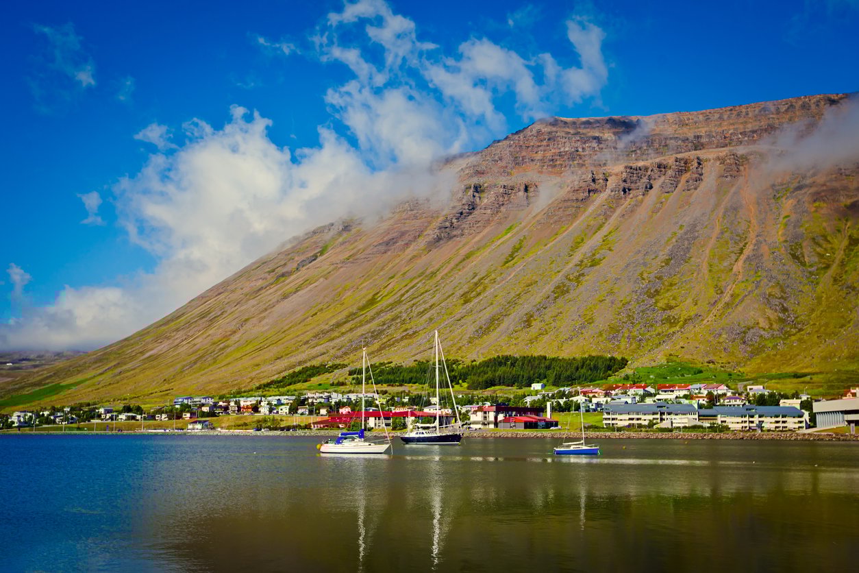 The vedute of the town of Isafjordur, bordered by the ocean and a steep mountain, the largest town of Westfjords, Iceland.